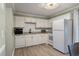Bright kitchen with white cabinets, stainless steel appliances, granite countertops and wood-look floors at 1836 Mepkin Rd # D4, Charleston, SC 29407