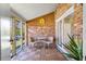 Cozy screened patio with brick walls, wood tiled floors, and comfortable seating area, perfect for relaxing at 1836 Mepkin Rd # D4, Charleston, SC 29407