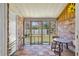 Enclosed patio with brick accent wall, wood-look floors, and views of the backyard at 1836 Mepkin Rd # D4, Charleston, SC 29407