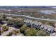 Beautiful aerial view showcasing a marsh-front property with mature trees, waterfront access, and neighborhood at 1902 Long Bend Dr # 1B, Seabrook Island, SC 29455