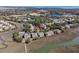 Scenic aerial view of homes near marshes with a neighborhood pool and tennis court adding to the lifestyle of the community at 1902 Long Bend Dr # 1B, Seabrook Island, SC 29455