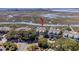 Stunning aerial view showcases a marsh-front property with mature trees, a community pier, and waterfront access at 1902 Long Bend Dr # 1B, Seabrook Island, SC 29455