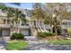Beautifully designed townhomes with elevated entrances, garages, and tropical landscaping offer curb appeal at 1902 Long Bend Dr # 1B, Seabrook Island, SC 29455