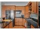 Traditional kitchen with stainless steel appliances, wood cabinets, and dark countertops at 1902 Long Bend Dr # 1B, Seabrook Island, SC 29455