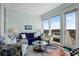 Bright living room with marsh views, comfortable seating, and large windows at 1902 Long Bend Dr # 1B, Seabrook Island, SC 29455