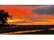 Dramatic sunset over the marsh with orange sky reflected in the waterway at 1902 Long Bend Dr # 1B, Seabrook Island, SC 29455