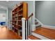 Hallway with wooden staircase and book shelves at 1902 Long Bend Dr # 1B, Seabrook Island, SC 29455