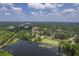 Wide aerial shot featuring a lake, neighborhood, and extensive green spaces under a partly cloudy sky at 2000 Middleton Dr, Goose Creek, SC 29445