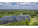 Scenic aerial view of a lush green community, showcasing the lake and surrounding tree landscape at 2000 Middleton Dr, Goose Creek, SC 29445