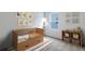 Cozy Bedroom with a wooden crib, soft rug, and charming animal artwork, creating a comforting space at 2000 Middleton Dr, Goose Creek, SC 29445