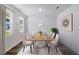 Formal dining area featuring a wooden table, seating for eight, modern decor, and large windows at 2000 Middleton Dr, Goose Creek, SC 29445