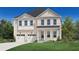 Charming two-story home with a manicured lawn, two-car garage, and welcoming front porch at 2005 Sea Water Dr, Charleston, SC 29412