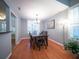 Dining room with hardwood floors, a modern chandelier, and plantation shutters at 2009 Arundel Pl, Mount Pleasant, SC 29464