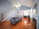 Open-concept living area with vaulted ceilings, hardwood floors, and a cozy fireplace at 2009 Arundel Pl, Mount Pleasant, SC 29464