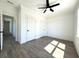 Spacious bedroom with wood-look floors, a modern ceiling fan, and natural light at 2012 Forest Ave, North Charleston, SC 29405
