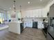 Modern kitchen with white cabinets, stainless steel appliances, and open layout to the living room at 2012 Forest Ave, North Charleston, SC 29405