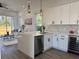 Open kitchen with a breakfast bar, modern pendant lighting, and seamless flow into the living area at 2012 Forest Ave, North Charleston, SC 29405