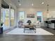 Open living room area with sliding glass door to the outside, plush sofa and modern furnishings at 2012 Forest Ave, North Charleston, SC 29405