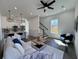 Sunlit living room with ceiling fan, plush seating, and a staircase, creating a cozy and inviting atmosphere at 2012 Forest Ave, North Charleston, SC 29405