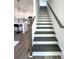 Elegant staircase featuring dark wood treads, white risers, and a complementary wood railing at 2012 Forest Ave, North Charleston, SC 29405