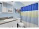 Clean bathroom showcasing a vanity, toilet, and a shower with a blue and white curtain at 203 Birmingham Dr, Summerville, SC 29486