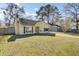 Inviting single-story home with a well-maintained front yard and long driveway under a blue sky at 203 Birmingham Dr, Summerville, SC 29486