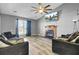 Bright living room boasts a fireplace, large window, vaulted ceiling and contemporary decor at 203 Birmingham Dr, Summerville, SC 29486
