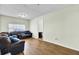 Spacious living room showcasing hardwood floors, ample natural light, and a comfortable sofa at 203 Birmingham Dr, Summerville, SC 29486