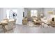 Bright living room with luxury vinyl floors and modern furniture, including a sofa and armchair at 203 West Bradford Pointe Dr, Summerville, SC 29483