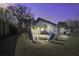 Backyard with a fire pit and outdoor seating under the twilight sky at 2058 Willowdale Ct, Mount Pleasant, SC 29466