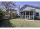 View of backyard with a screened porch, wooden fence, and mature trees at 2058 Willowdale Ct, Mount Pleasant, SC 29466