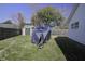 View of privacy fence and yard with shed and covered equipment at 2058 Willowdale Ct, Mount Pleasant, SC 29466