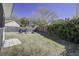 Large backyard with wooden fence, Adirondack chairs, a cozy fire pit, and mature trees at 2058 Willowdale Ct, Mount Pleasant, SC 29466