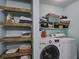 Efficient laundry room with washer, dryer, and shelving for organized storage at 2058 Willowdale Ct, Mount Pleasant, SC 29466