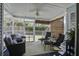 Relaxing screened porch with comfortable seating, ceiling fan, and view of the landscaped backyard at 2058 Willowdale Ct, Mount Pleasant, SC 29466