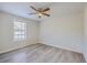 Neutral bedroom with natural light from the large window, featuring a ceiling fan and hardwood floors at 206 Braly Dr, Summerville, SC 29485