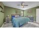 Bedroom with natural light features a ceiling fan, light green walls, hardwood floors, and a queen size bed at 206 Braly Dr, Summerville, SC 29485