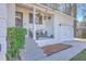 Inviting front porch with seating area, hanging plants, and stylish front door at 206 Braly Dr, Summerville, SC 29485