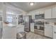 Open kitchen with stainless steel appliances, white cabinets, granite countertop, and hardwood floors at 206 Braly Dr, Summerville, SC 29485