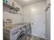 A well appointed laundry room features a modern washer and dryer with updated shelving and fixtures at 206 Braly Dr, Summerville, SC 29485
