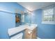 This bathroom features neutral vanity and blue walls at 21 Rivers Point Row Row # 17 B, Charleston, SC 29412