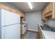 Efficient kitchen featuring wood cabinets, white appliances, and a practical layout with new vinyl floors at 21 Rivers Point Row Row # 17 B, Charleston, SC 29412