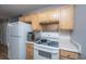 This kitchen features wood cabinets, white appliances, and modern backsplash at 21 Rivers Point Row Row # 17 B, Charleston, SC 29412