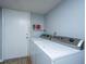 Efficient laundry area with front-loading machines and storage shelves, next to the exterior door at 21 Rivers Point Row Row # 17 B, Charleston, SC 29412