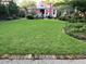 Manicured lawn with a view of the house, patio, and lush landscaping at 214 E Doty Ave, Summerville, SC 29483