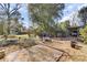 Picturesque backyard with a brick patio, established trees, and cozy outdoor seating at 214 E Doty Ave, Summerville, SC 29483