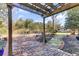 Inviting brick patio with a pergola, seating area, and a charming pathway to a shed at 214 E Doty Ave, Summerville, SC 29483