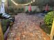Brick patio area with a dining set and red umbrellas, perfect for outdoor entertaining at 214 E Doty Ave, Summerville, SC 29483