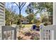 Lush backyard with a brick patio, outdoor seating, and a charming shed at 214 E Doty Ave, Summerville, SC 29483
