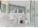 Well-lit bathroom featuring a pedestal sink, walk-in shower, and classic tile flooring at 214 E Doty Ave, Summerville, SC 29483